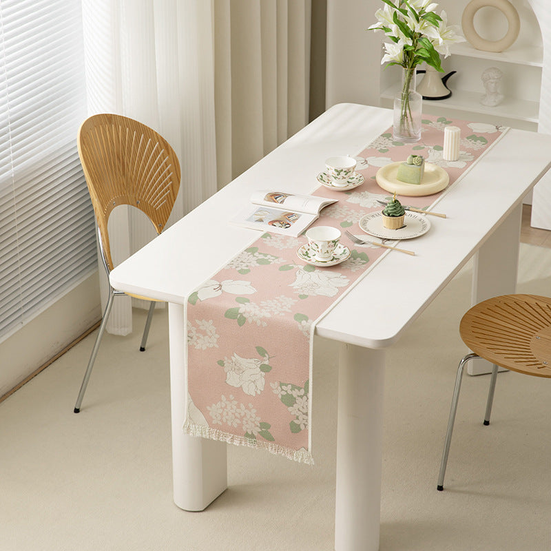 Woven table runner with floral jacquard pattern and fringed edge Kalsten