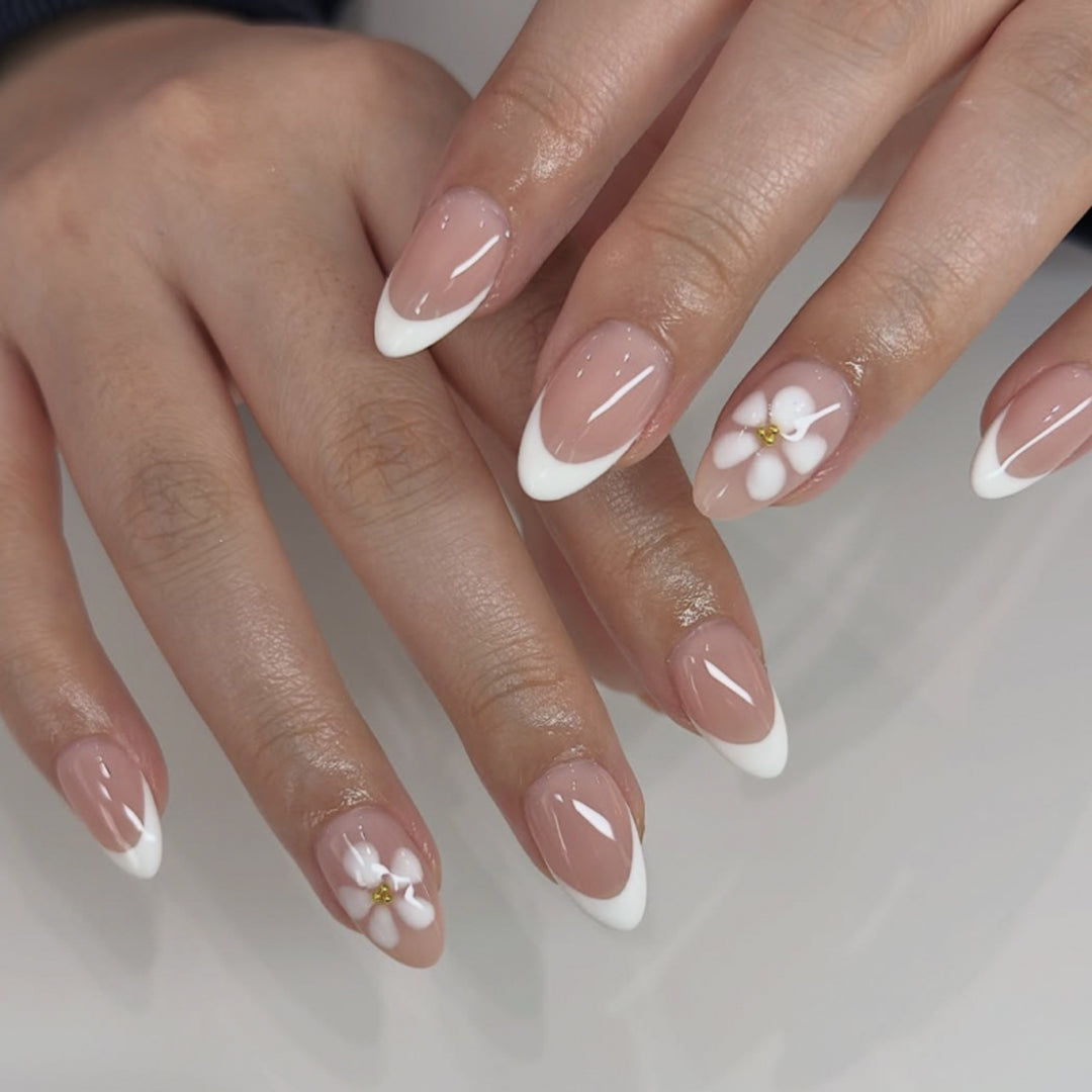 Artful nail extensions with flower design and elegant French tips Kalsten