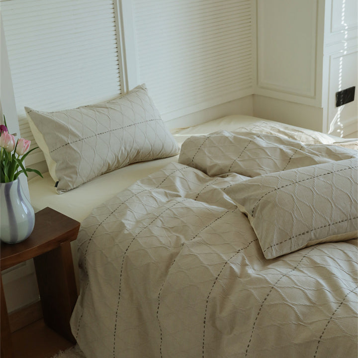 Reversible quilted bedding set made of cotton blend with textured leaf quilting and satin finish back
