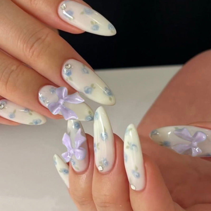 Artful stiletto nails with delicate flower patterns and glitter accents Kalsten