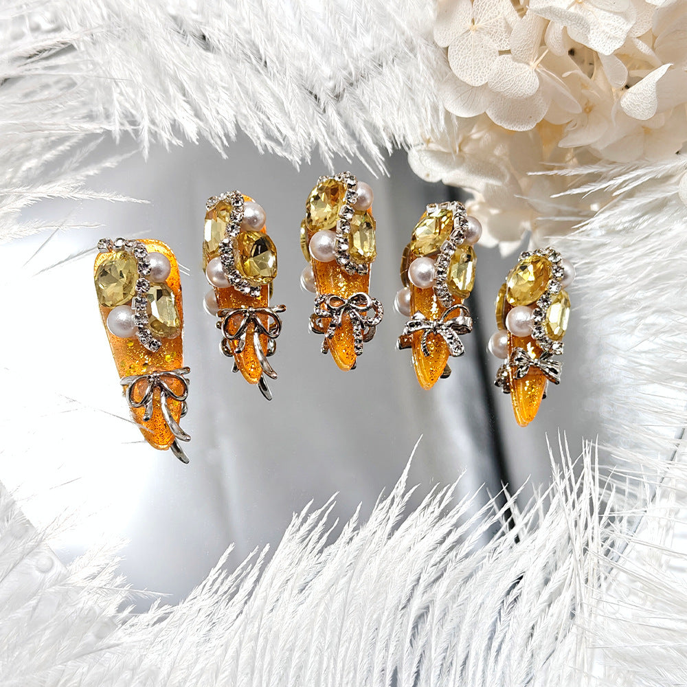 Glamorous artificial nails with rhinestones and pearl embellishments Kalsten