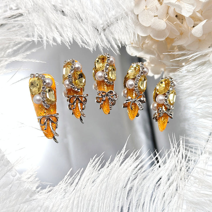 Glamorous artificial nails with rhinestones and pearl embellishments Kalsten