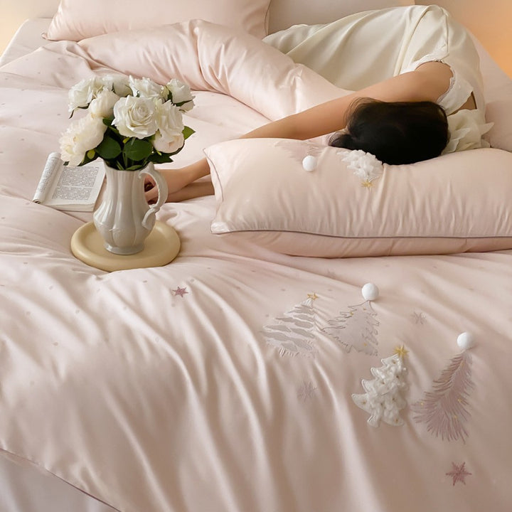 Luxurious satin bedding set with winter pine embroidery and pompom applications