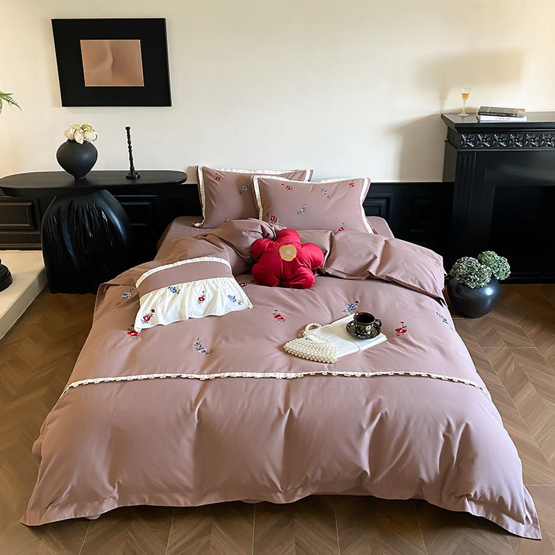 Duvet cover set made of premium cotton satin with subtly embroidered wildflower motif and ruffle edge