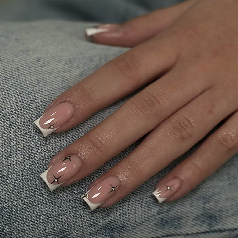 Artificial nail extensions with elegant French tip and glitter accents Kalsten