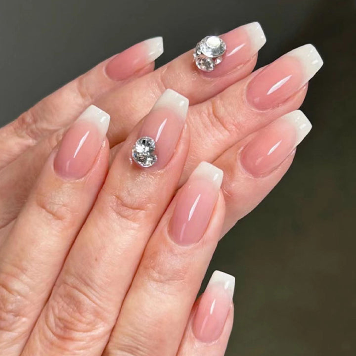 Artful nail extensions with elegant French tip and rhinestone embellishments Kalsten