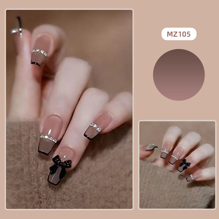 Elegant nail design with bow and rhinestone details Kalsten