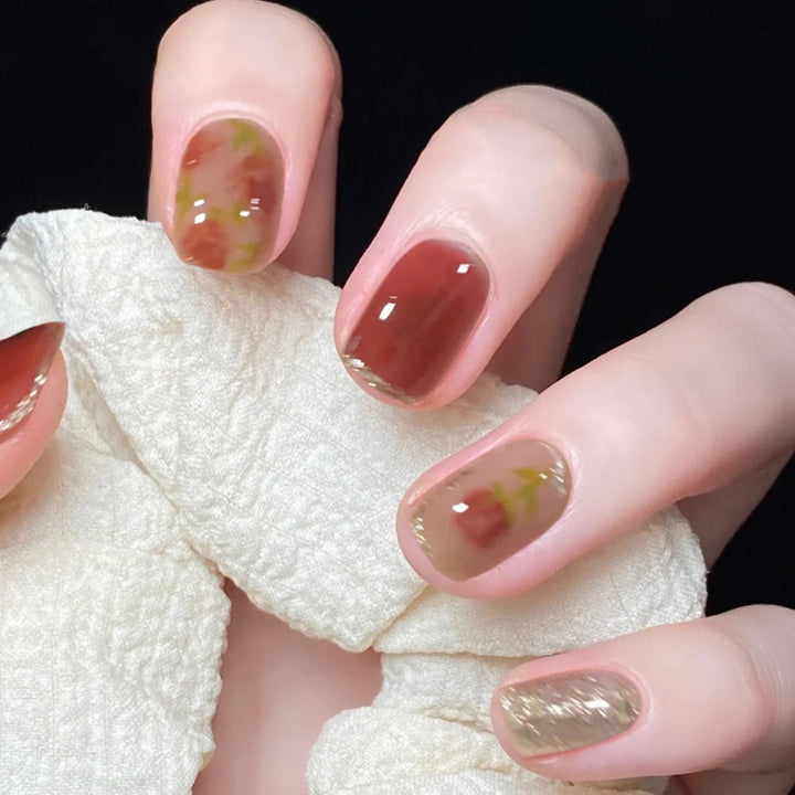 Artful nail art with natural gradient and floral accents Kalsten