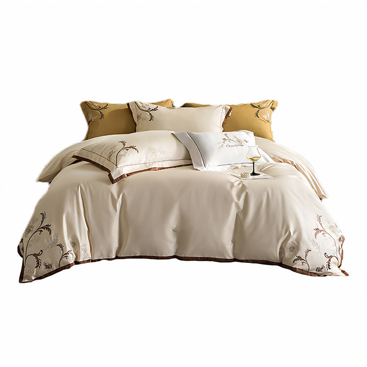 Luxurious embroidered satin bed linen set with floral corner motif and contrast piping
