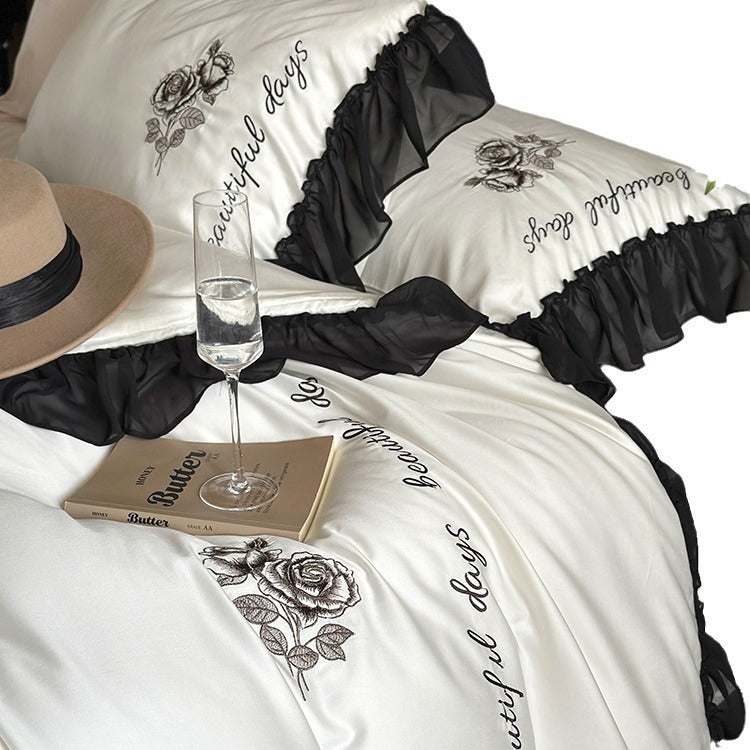Bedding set made of silky-soft cotton satin with ruffle, delicate rose embroidery, and decorative lettering