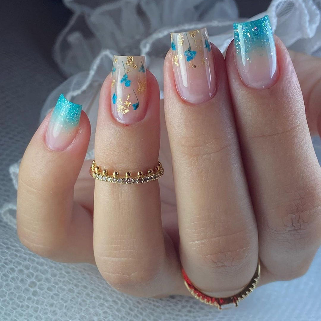 Artful acrylic nails with floral design and glitter effects Kalsten