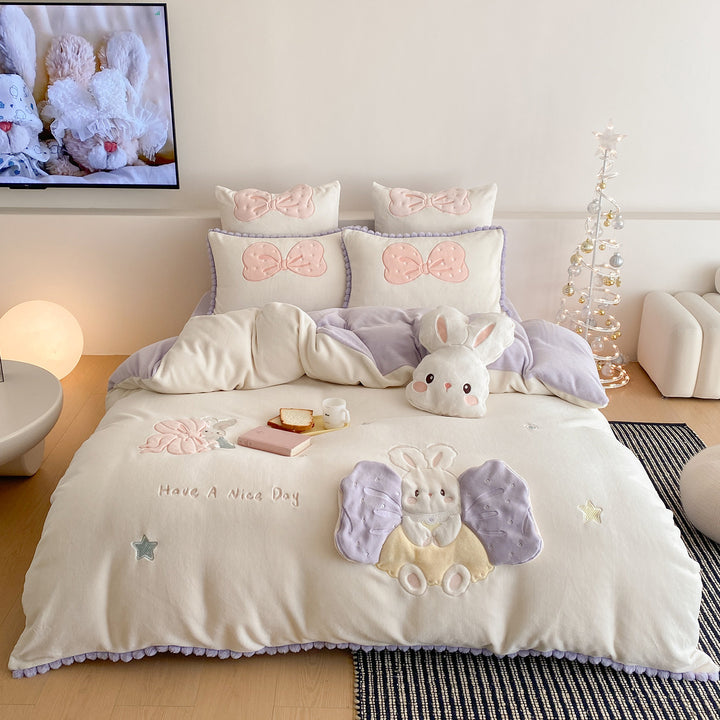 Cozy quilted bedding set with plush appliqué and pompom trim