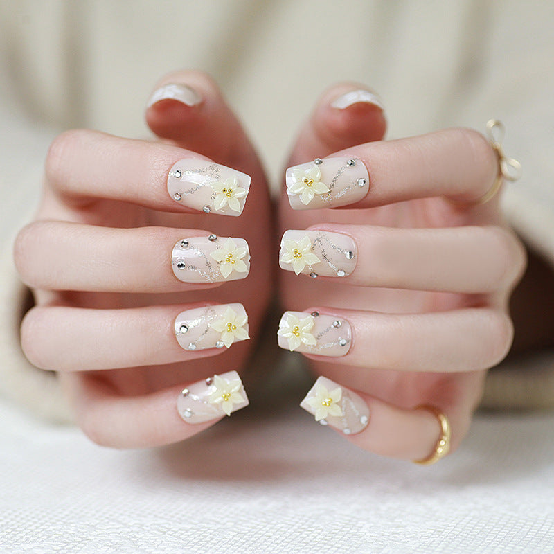 Artificials nails with sparkling rhinestone accents and elegant flower embellishments Kalsten