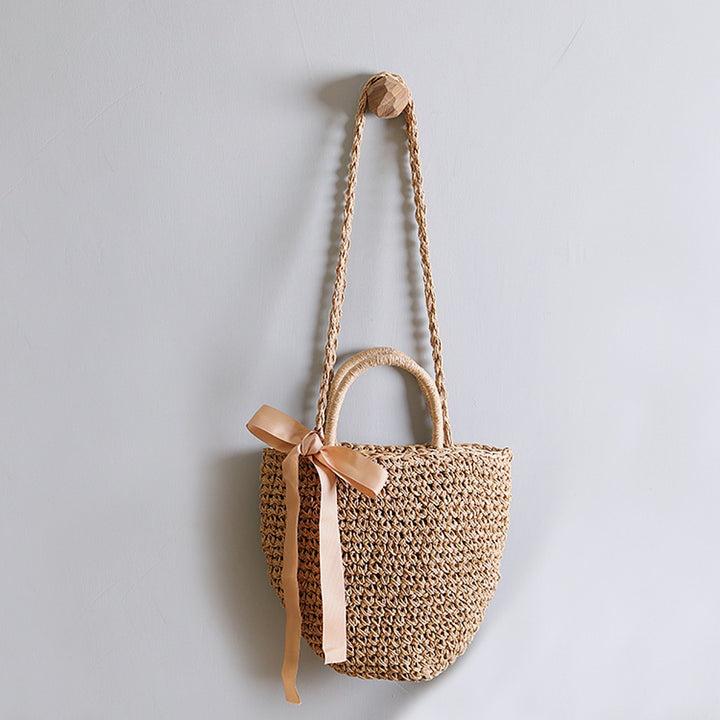 Basket bag with stylish carrying handles and decorative bow Kalsten