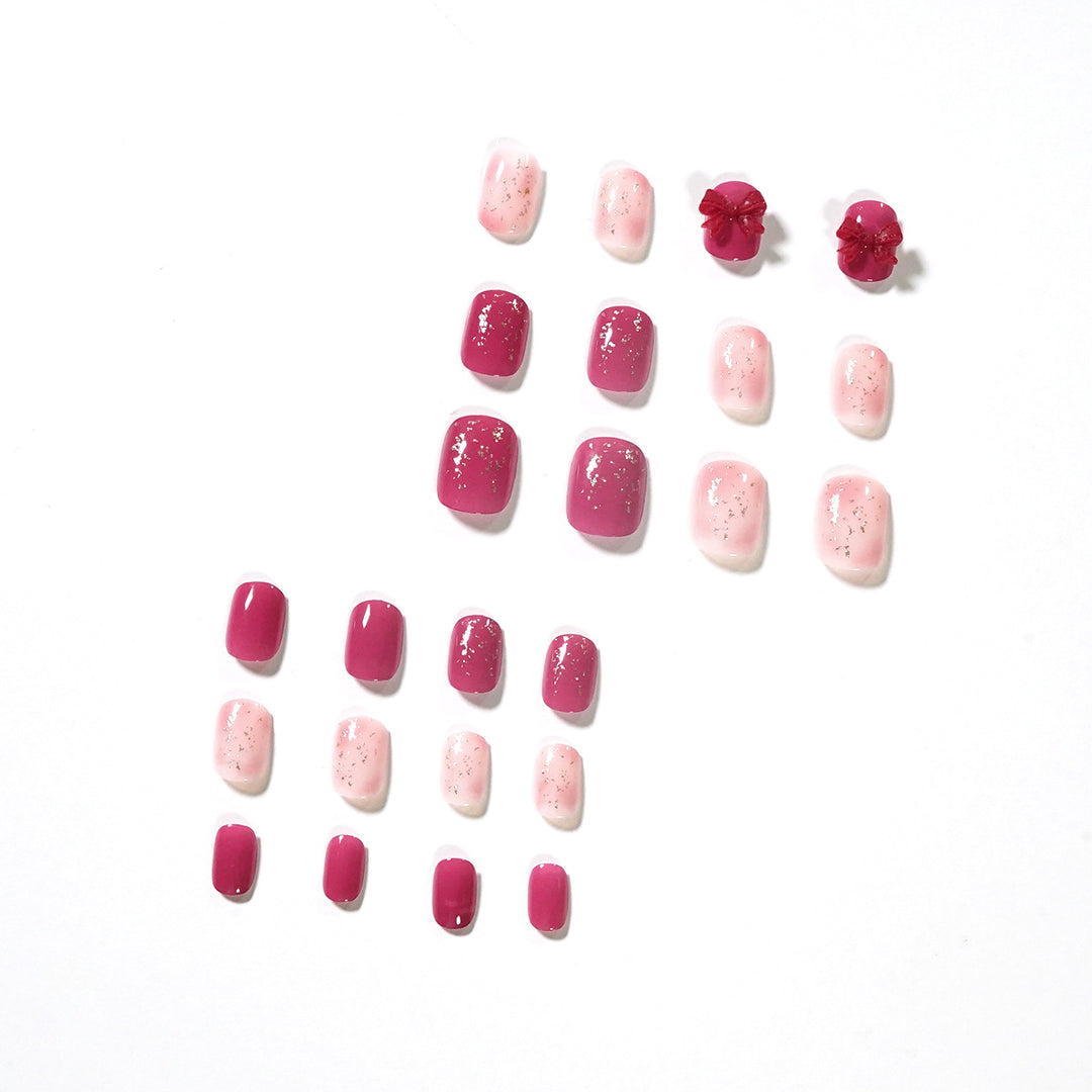 Artificial nail art with glitter embellishments and cute bow motif Kalsten