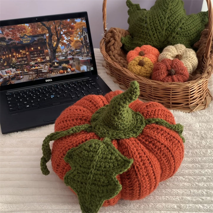 Hand-crocheted decorative cushion in pumpkin shape with leaf and vine application