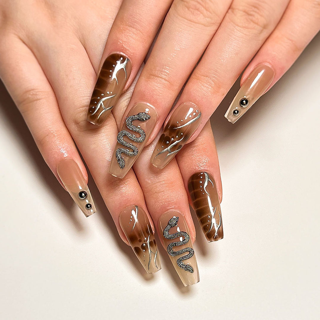 Artistic fingernails with snake and glitter accents Kalsten
