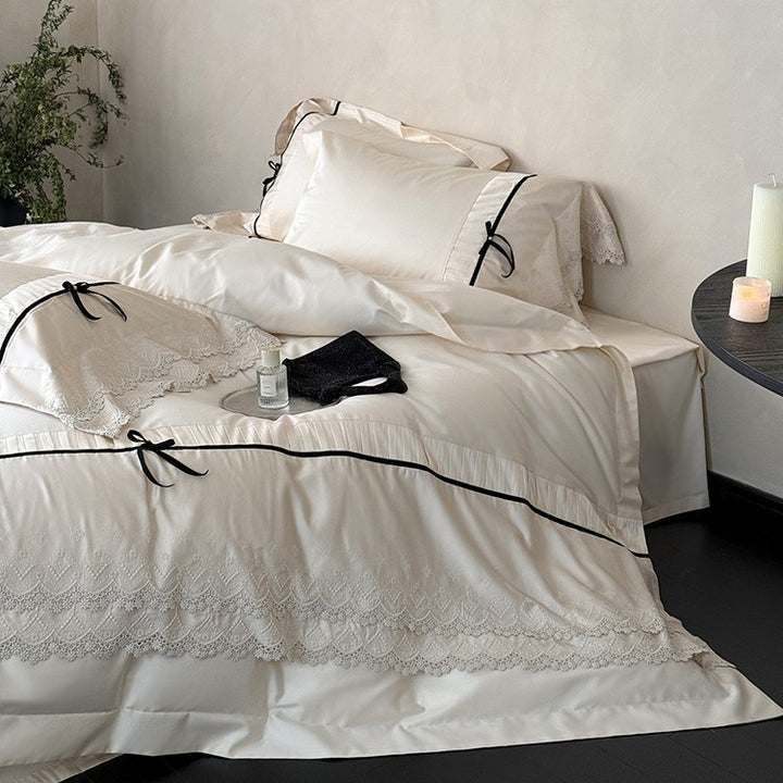 Fine cotton satin bedding set with lace ruffle, contrasting decorative ribbons and hotel closure