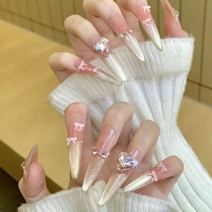 Art nail set with sparkling tips and delicate bow decorations Kalsten
