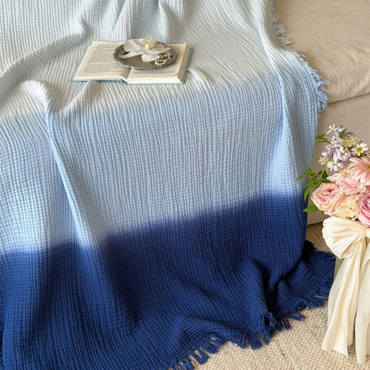 Large waffle blanket with ombre coloring and decorative fringes