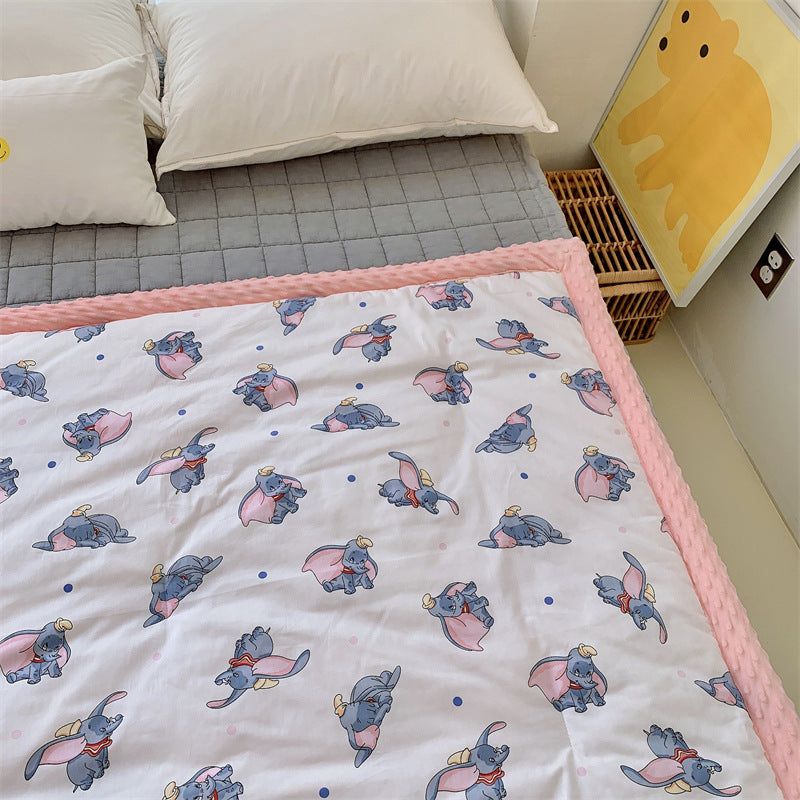 Children's quilt with colorful dinosaur print and soft minky border