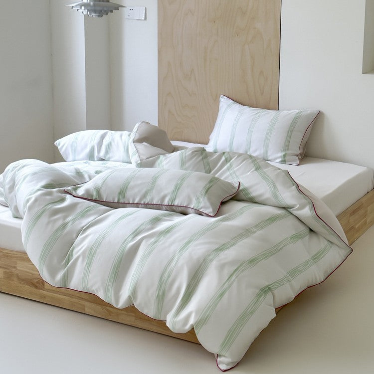 Modern striped bedding set made of cotton satin with hand-drawn stripes and contrasting piping