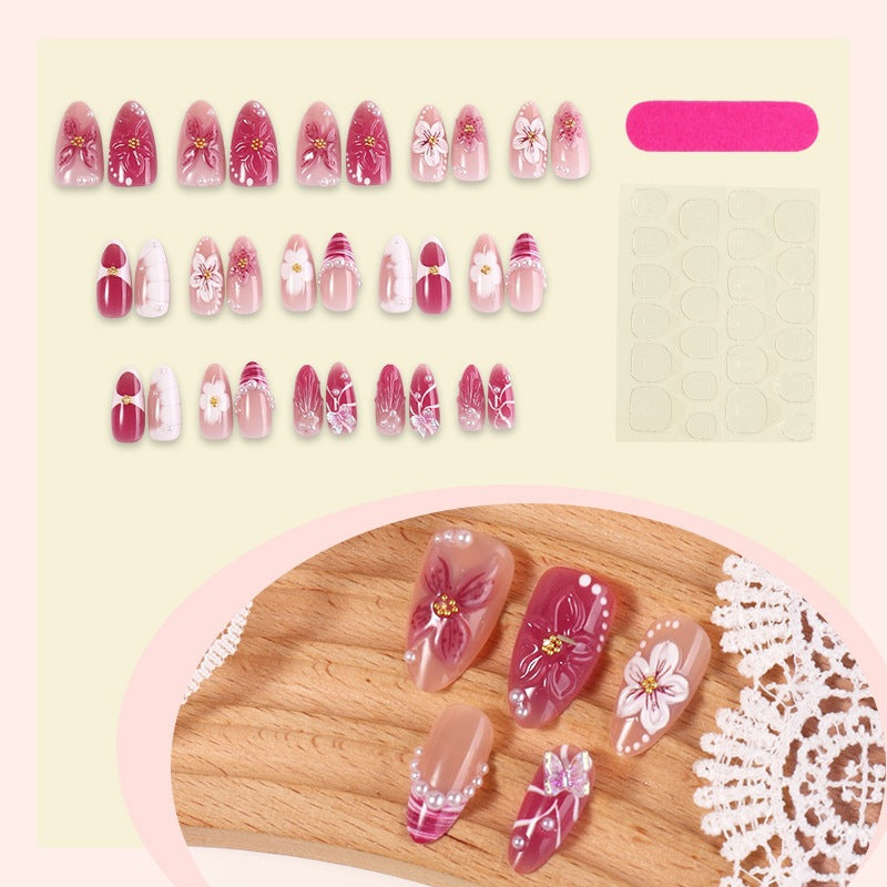 Creative acrylic nail set with floral accents and glitter decorations Kalsten