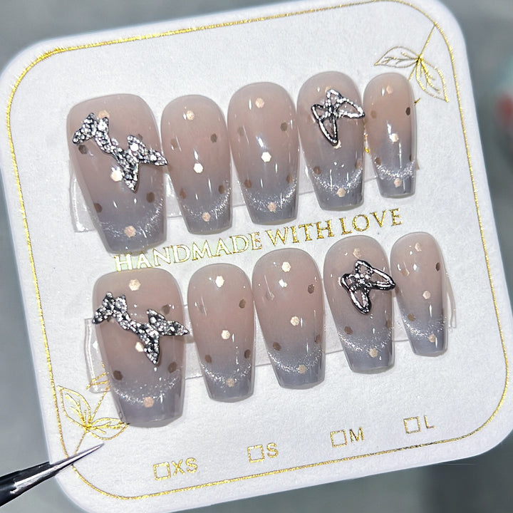 Artificial nail art with glitter details and bow accents Kalsten