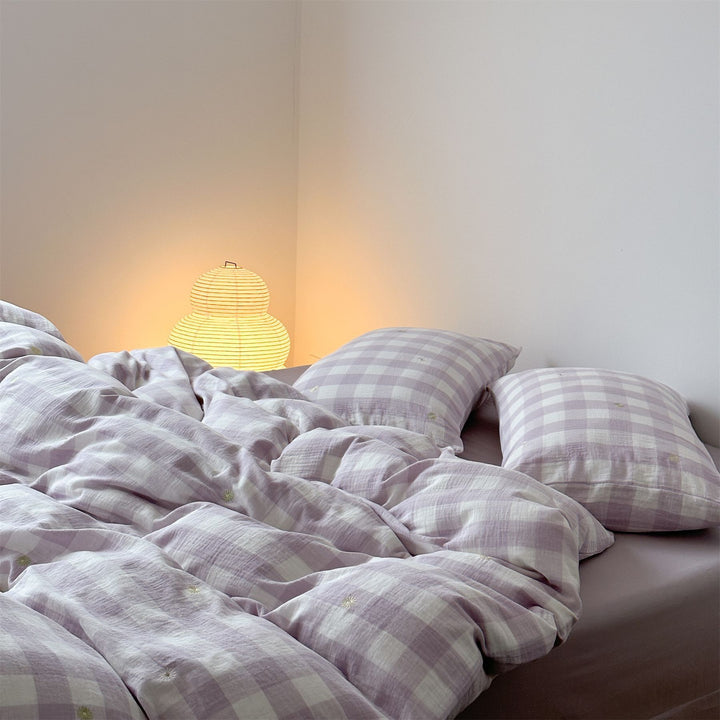 Duvet cover set made of lightweight cotton muslin featuring a checked texture and decorative embroidery design