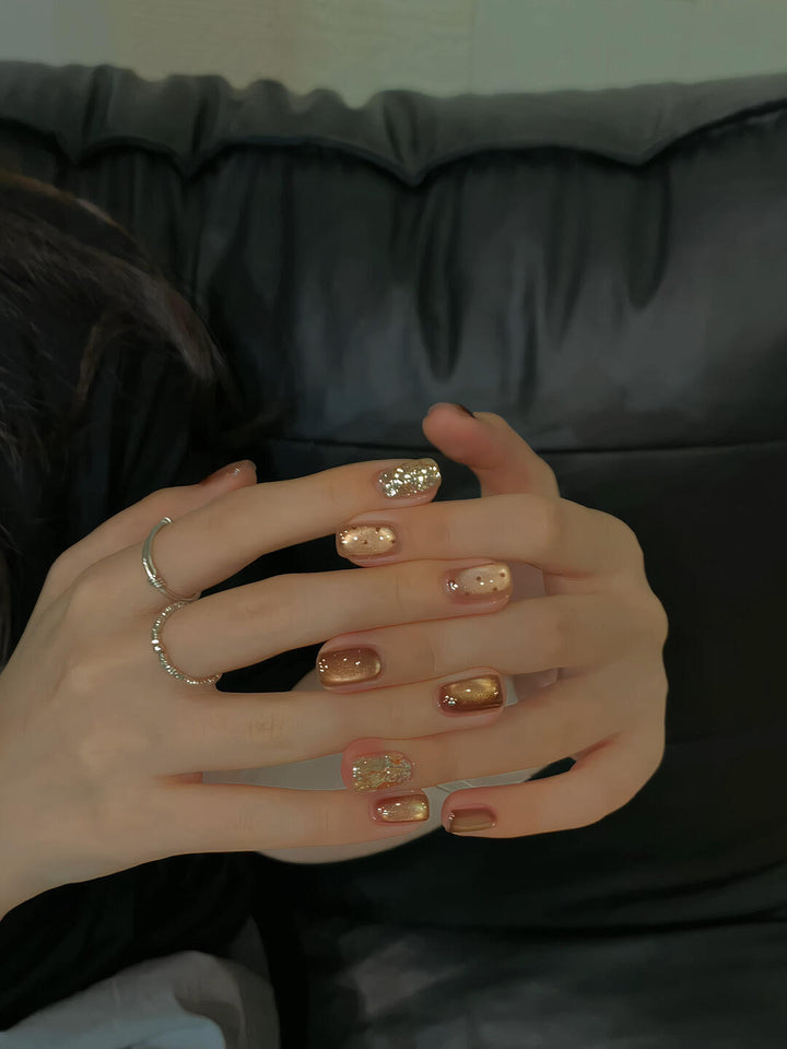 Elegant artificial nails with shimmering effects and sparkling accents Kalsten