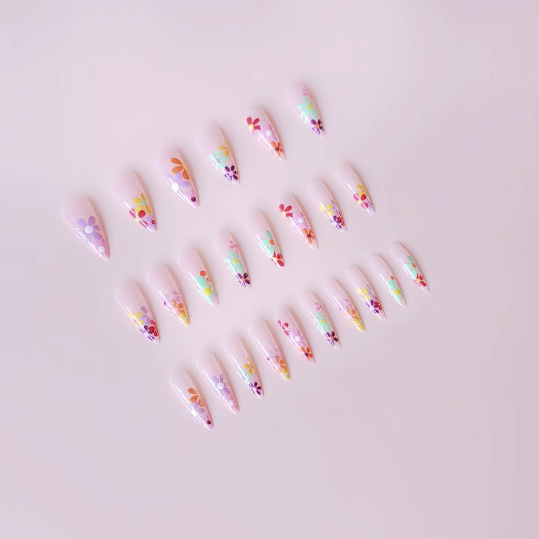 Acrylic nail set with vibrant floral designs and sharp accents Kalsten