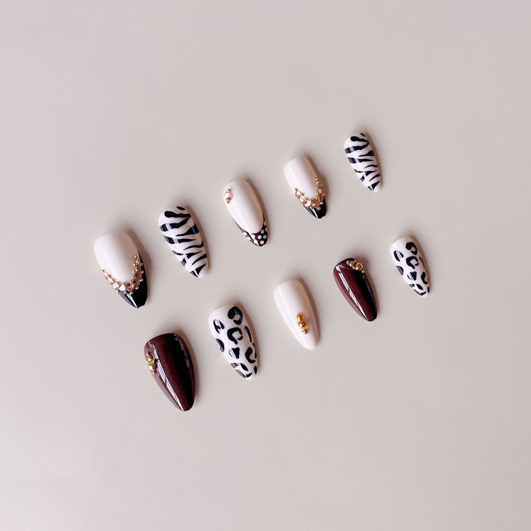 Acrylic nail set with luxurious animal motif designs and glamorous accents Kalsten