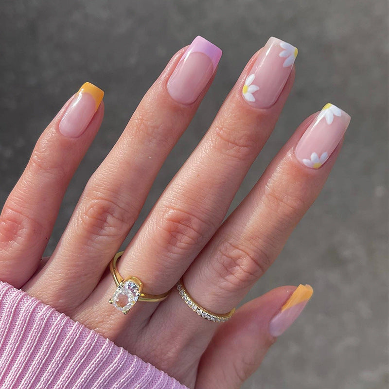 Artistic acrylic nails with floral design and creative color accents Kalsten