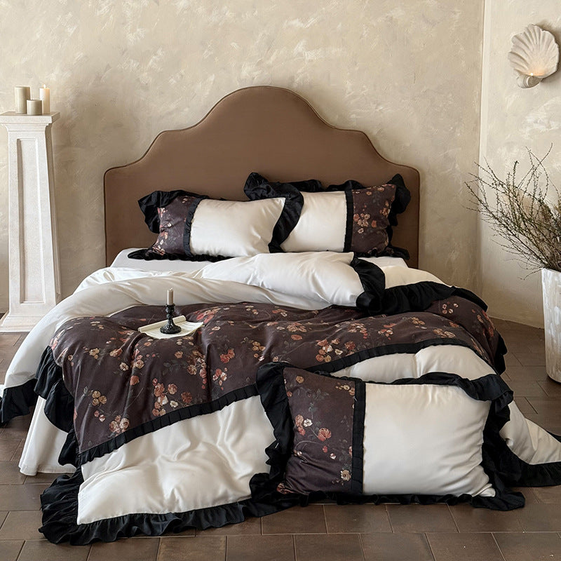 Reversible cotton satin bedding set with floral design and decorative ruffle trim