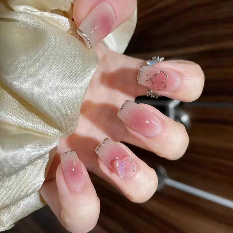 Artistic acrylic nails with heart and butterfly motifs Kalsten