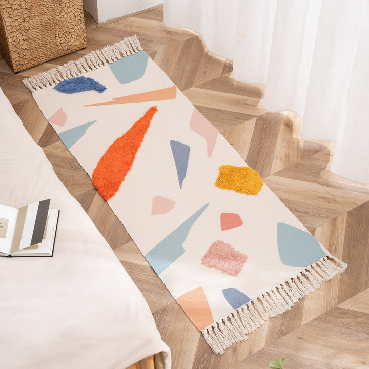 Woven runner with hand-tufted 3D applications and fringes
