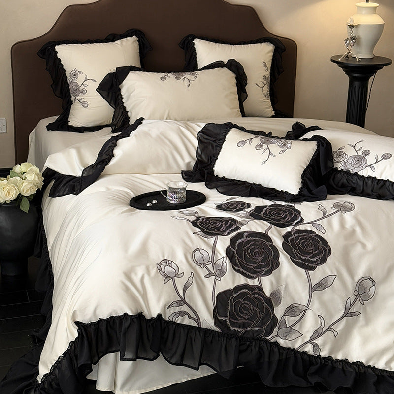 Luxurious bedding set with rose embroidery and ruffled hem