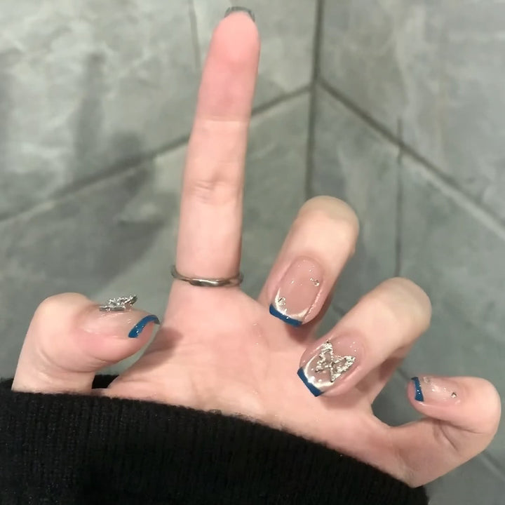 Artificial nails with trendy French tips and decorative glitter accents Kalsten