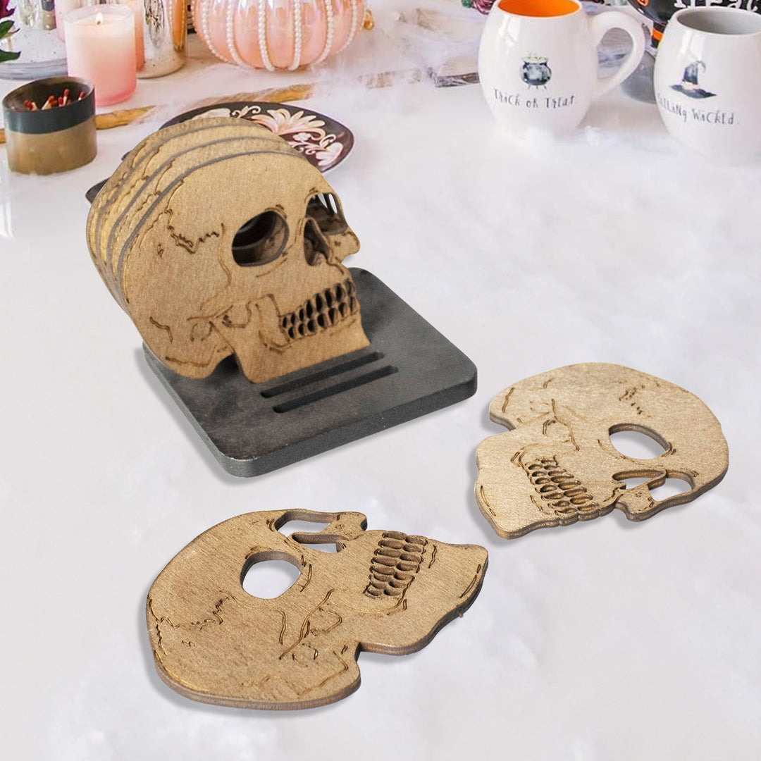 Set of laser-engraved wooden coasters in skull shape with storage stand
