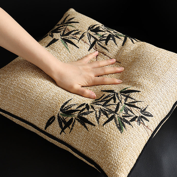 Square decorative pillow with embroidered bamboo design and natural linen texture