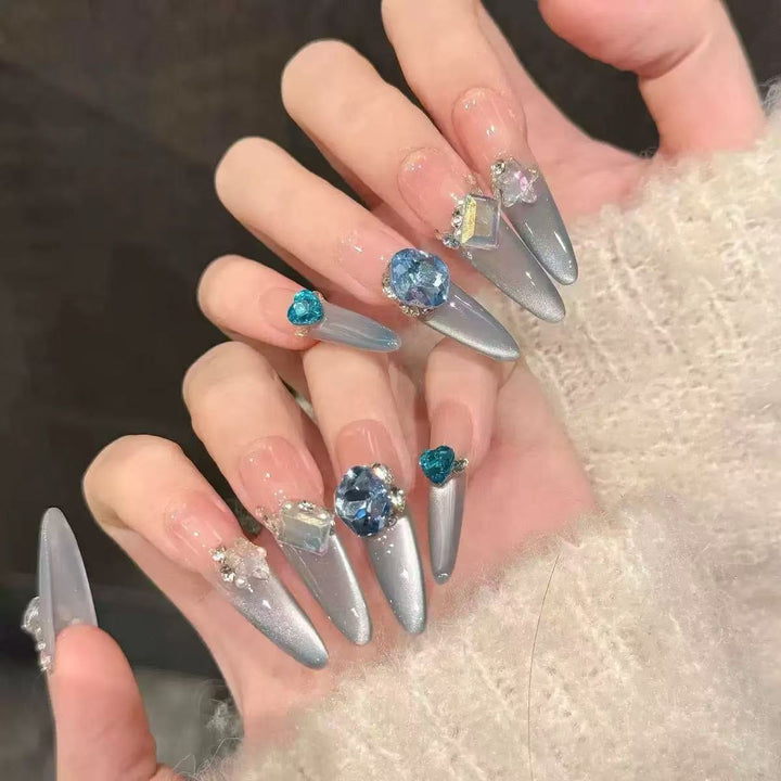 Acrylic nail set with elegant tips and glamorous rhinestone accents Kalsten