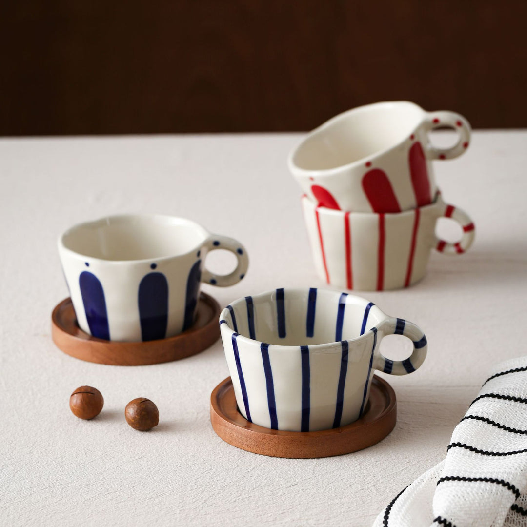 Ceramic espresso cup with round wooden coaster and handcrafted stripe pattern