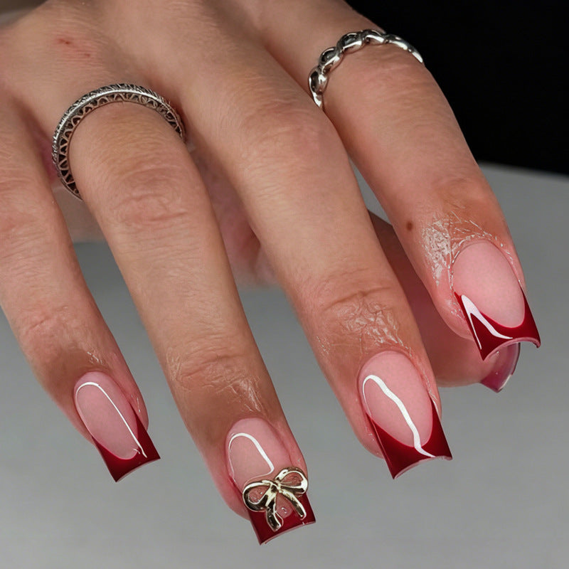 Artificial nail set with elegant red tips and refined bow decorations Kalsten