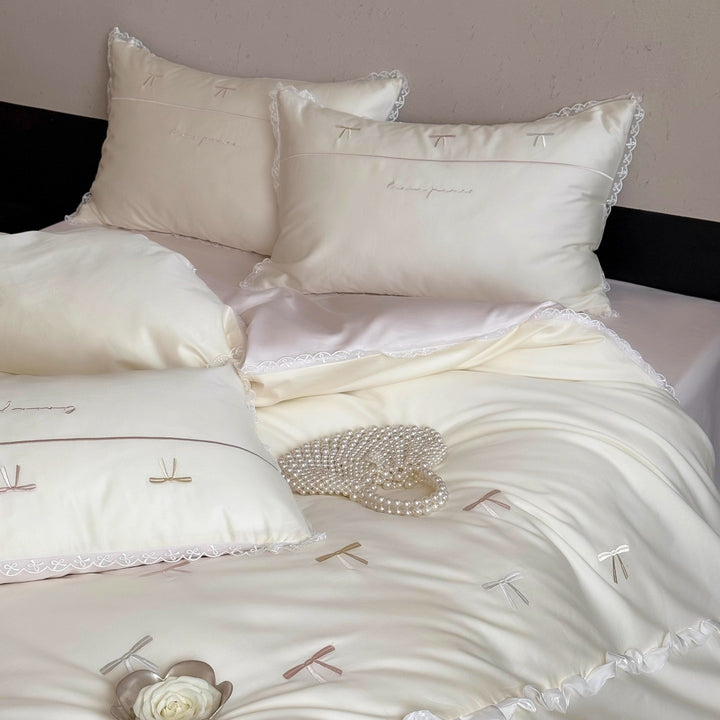 Elegant bedding set made of silky fine satin with embroidered bows and lace trim