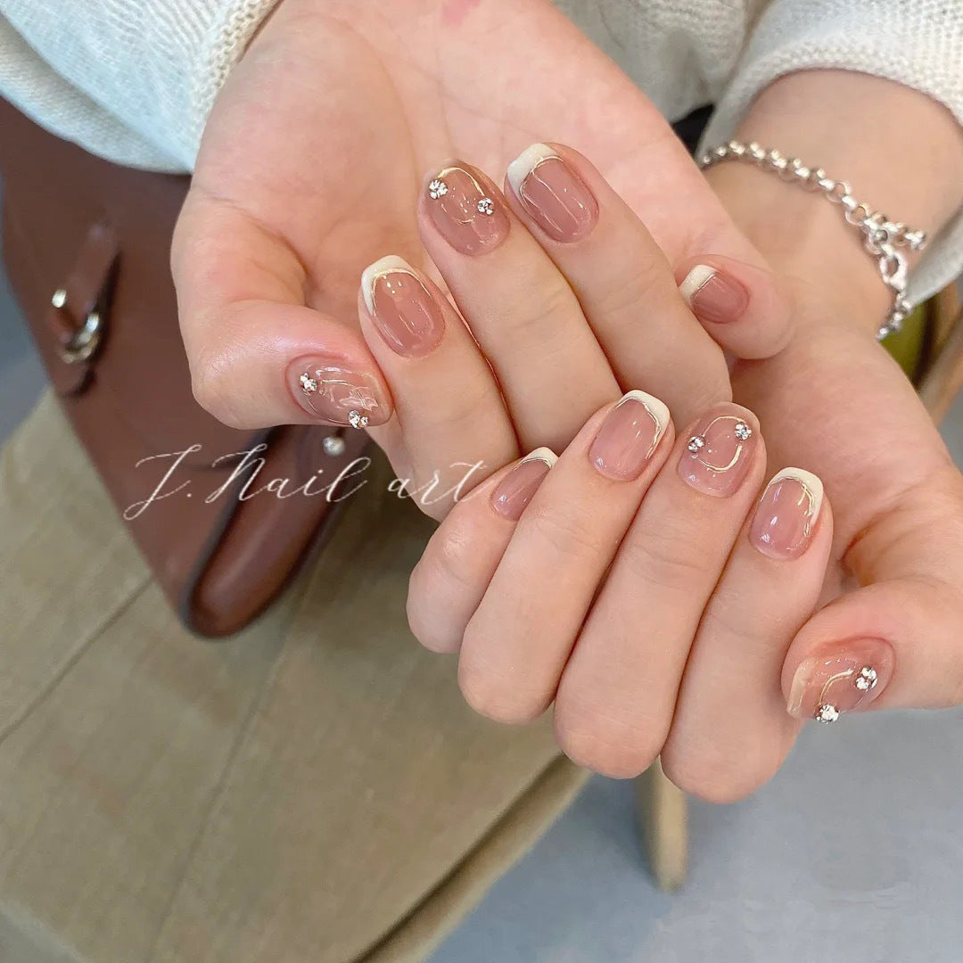 Acrylic nail set with elegant French tips and glitter accents Kalsten