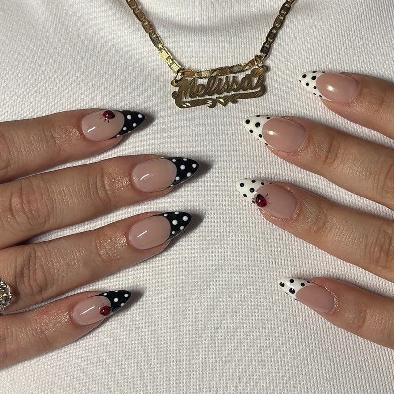 Acrylic nail set with polka-dotted accents and sparkling details Kalsten