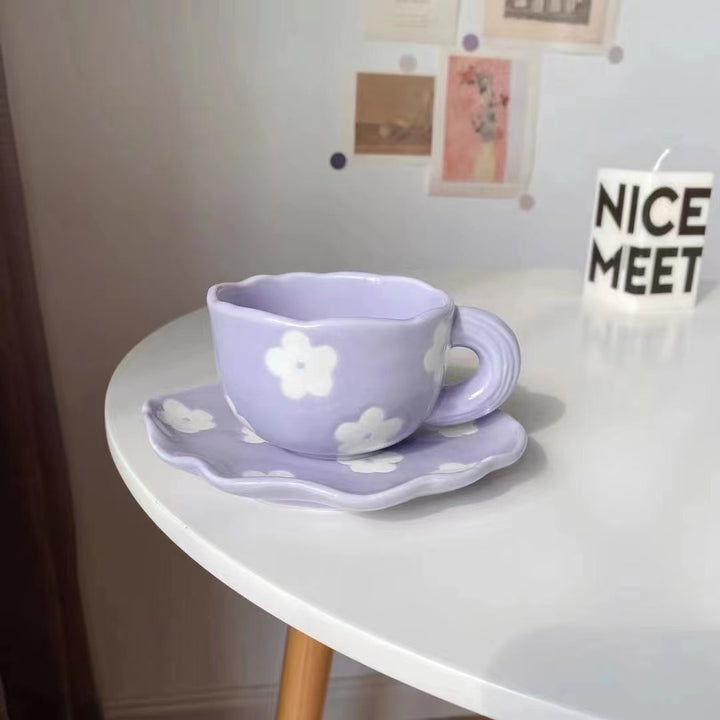 Ceramic coffee set with playful bear reliefs and organic wave saucer