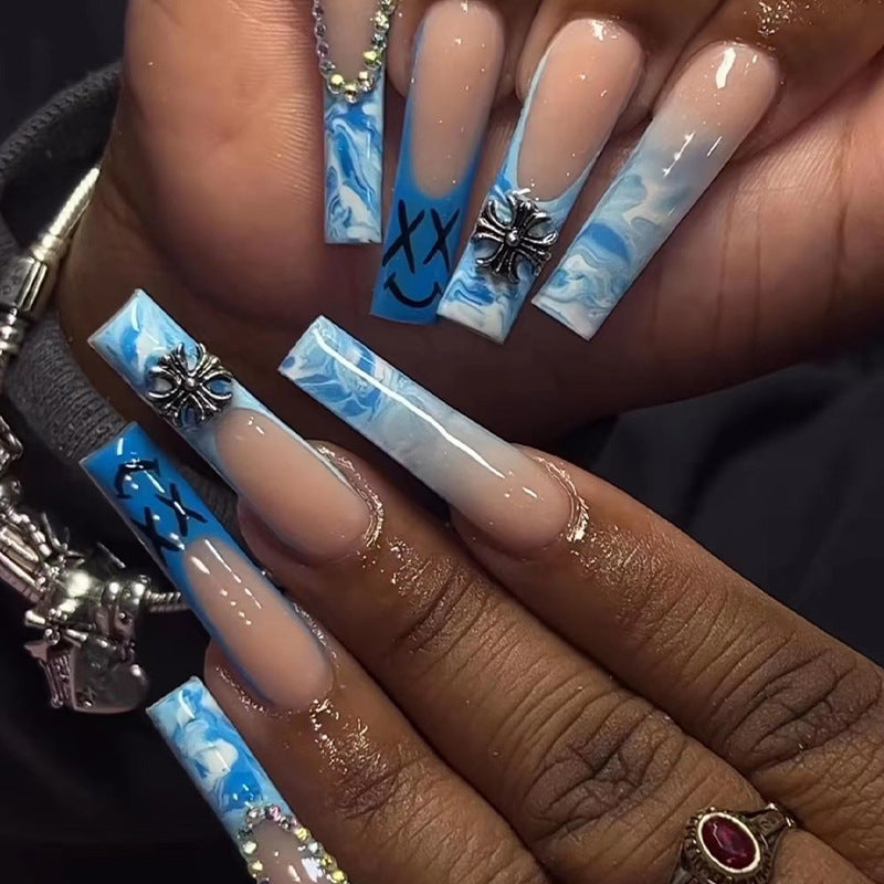 Artistic acrylic nails with marbled design and unique embellishments Kalsten
