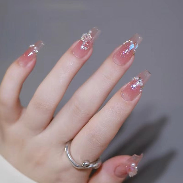 Glamorous artificial nails with delicate flower and glitter effects Kalsten