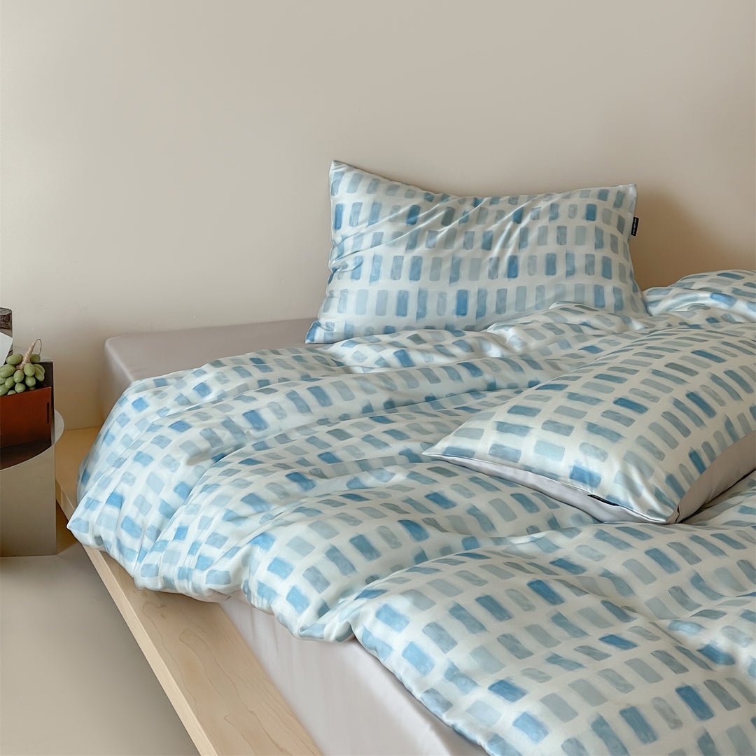 Luxurious satin bedding set with floral watercolor print, ruffled edges and reversible function